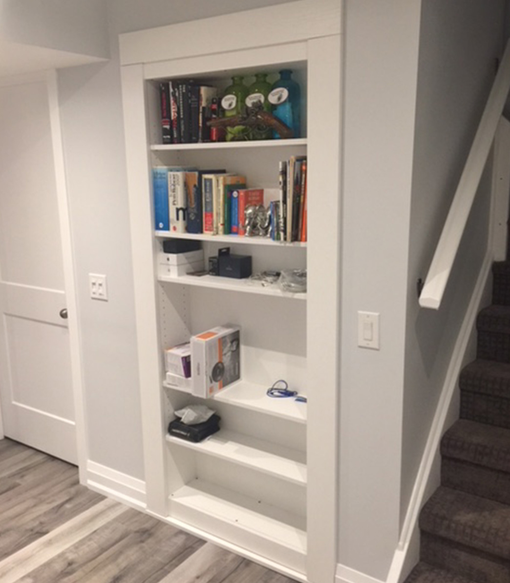 secret bookcase door next to stairs