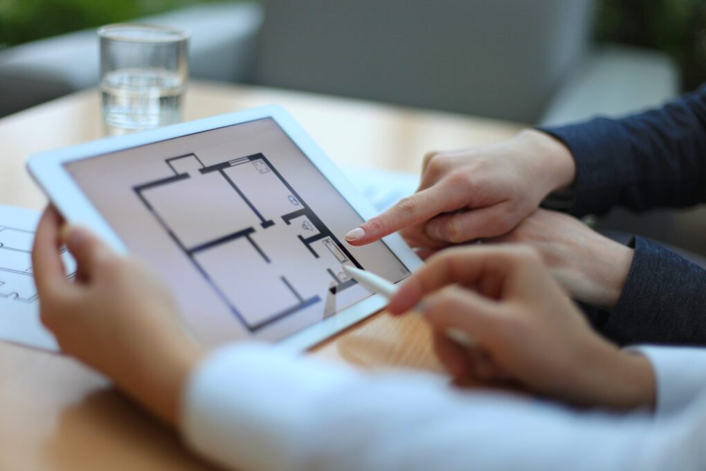 two people looking at a house design layout