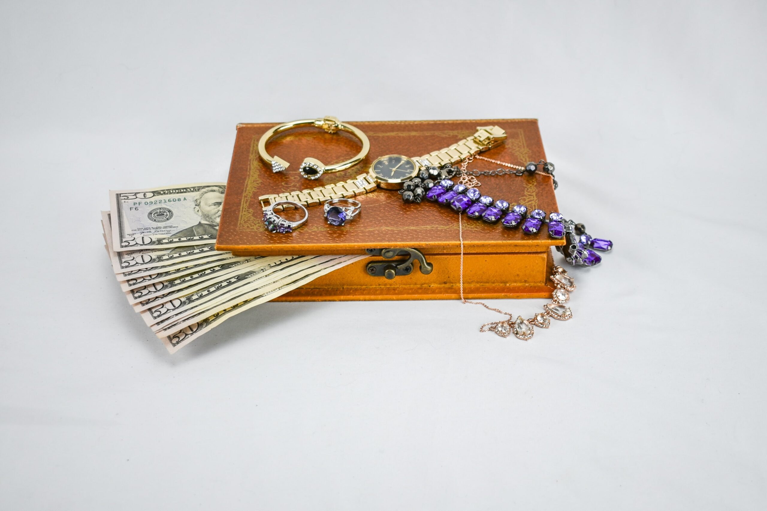 jewelry box with jewelry on top and money sticking out