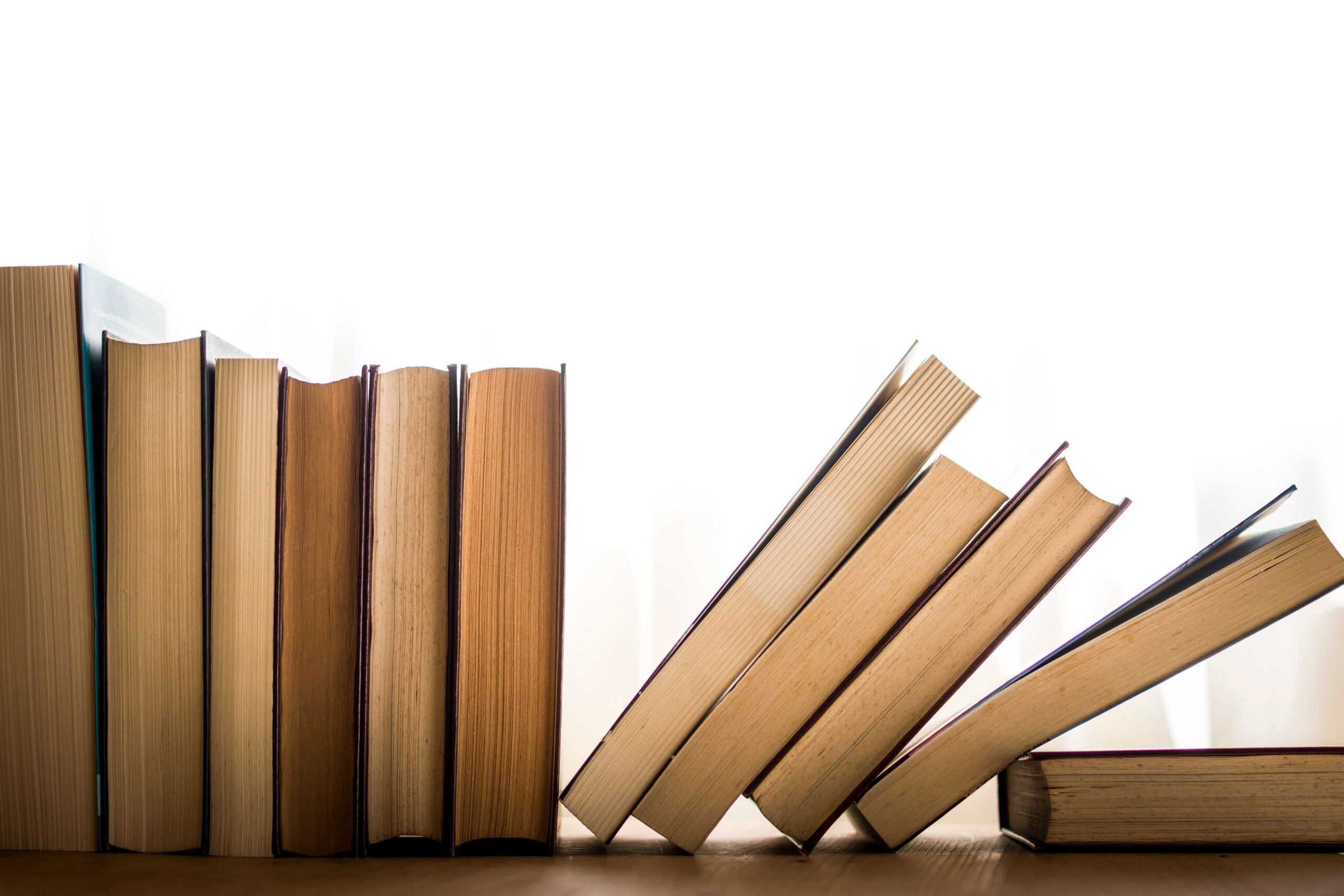 books in a line falling over