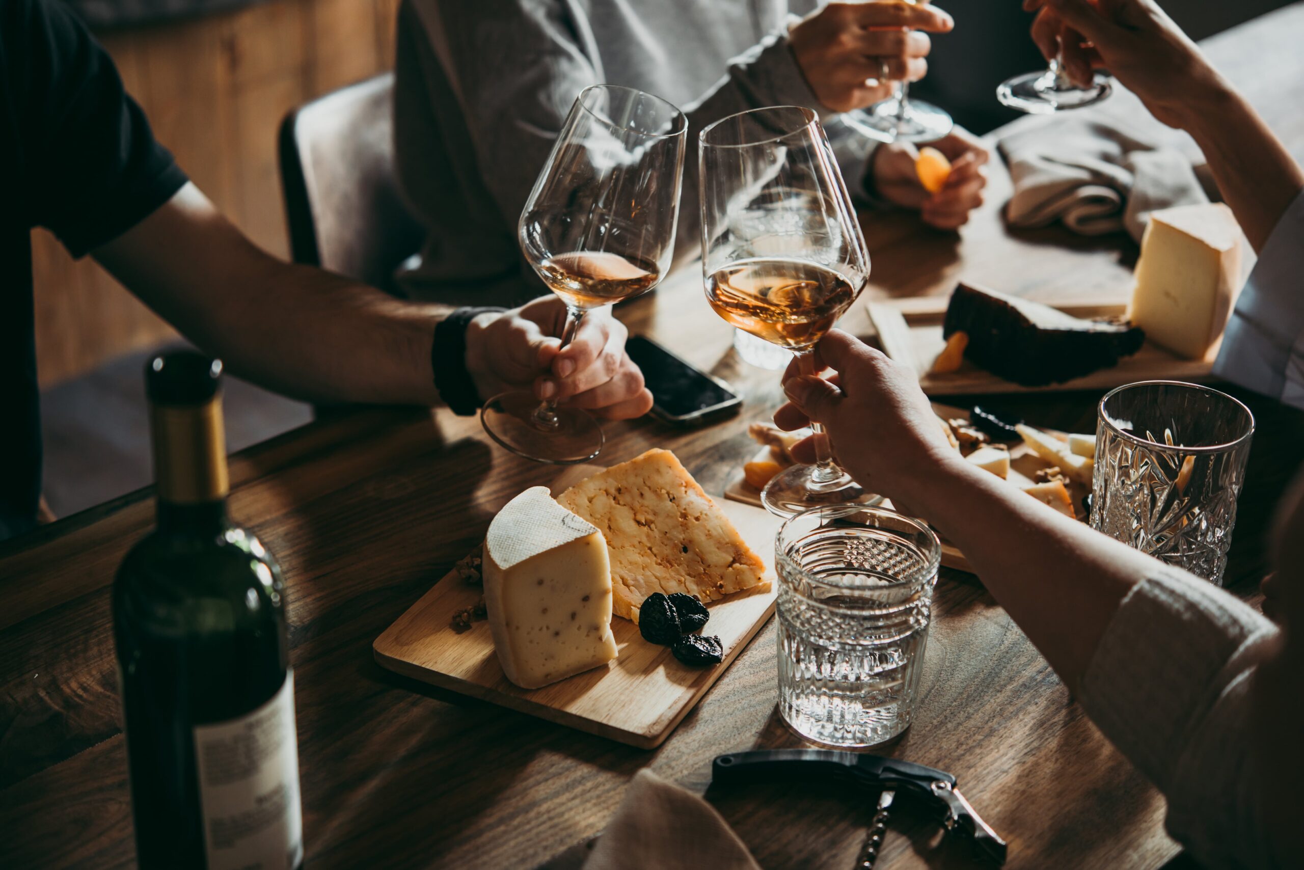 toasting wine glasses at a dinner party.