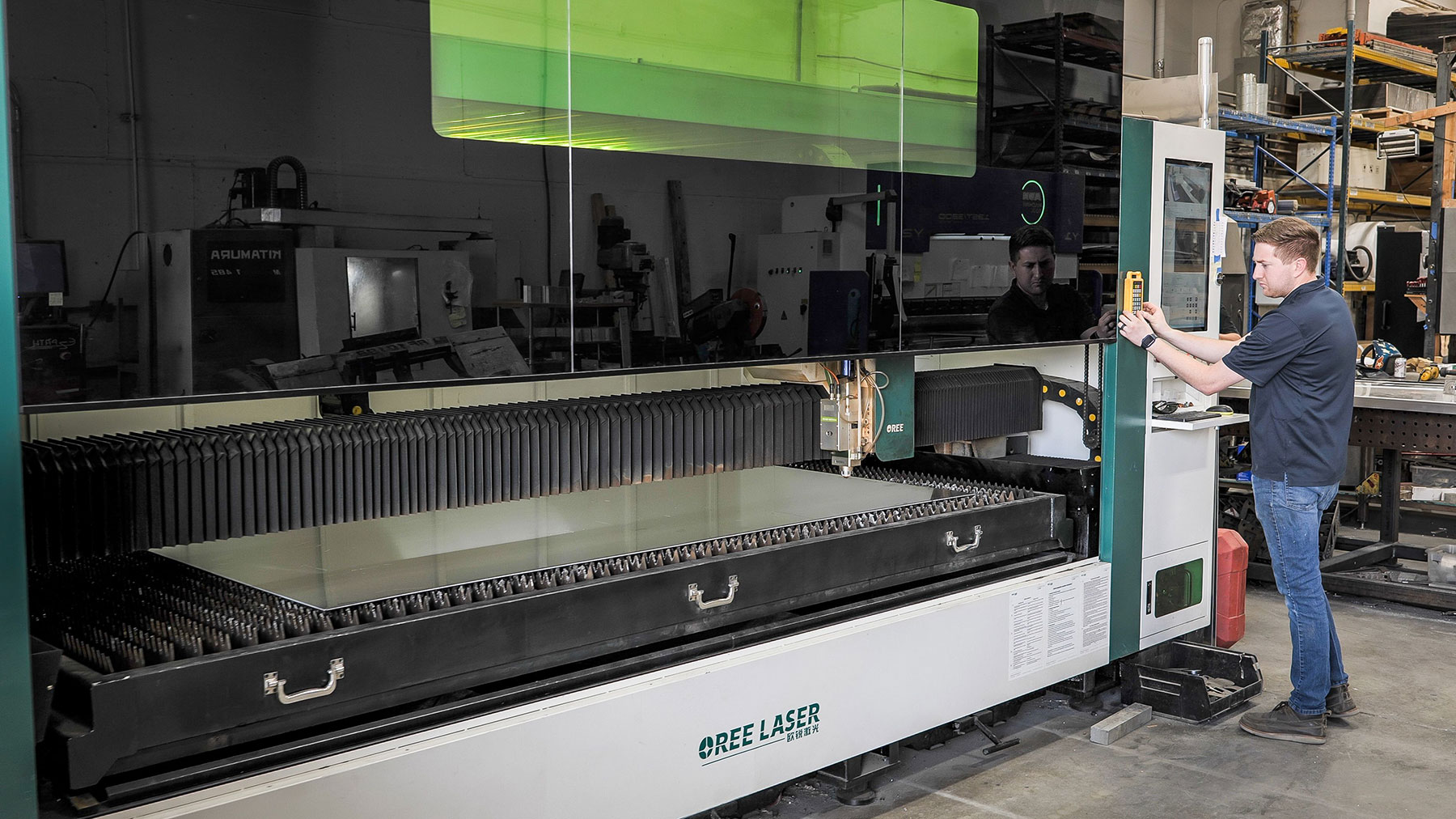 CHE employee setting up the laser machine