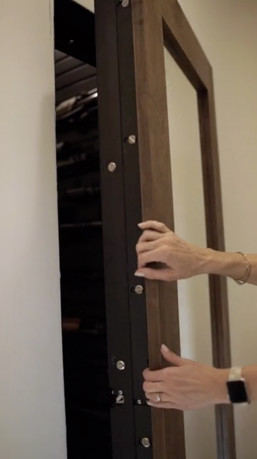 Vault mirror door opening to secure gun room storage.