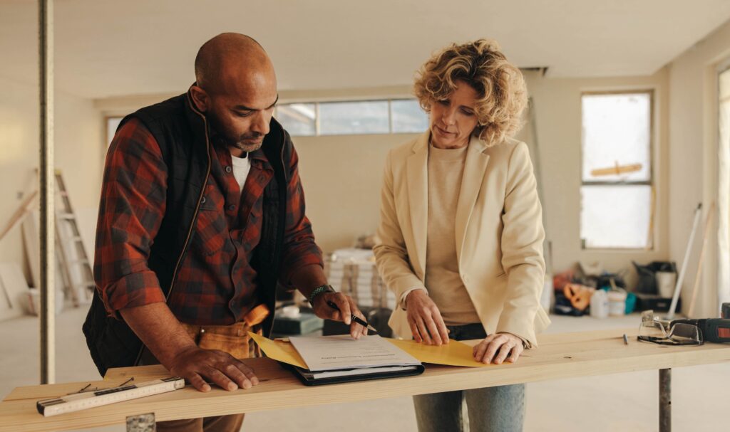 A contractor and woman looking at a project