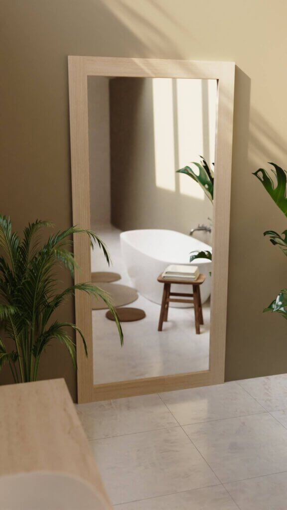 Modern bathroom with DIY hidden door disguised as a minimalist wood-framed mirror, blending seamlessly with natural tones and lush plants. Hidden Door Store.
